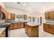 Well-lit kitchen featuring granite countertops, tiled flooring, and plentiful oak cabinetry at 7002 E Exmoor Dr, Mesa, AZ 85208
