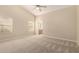 Serene bedroom featuring carpet flooring, a ceiling fan, and an ensuite bathroom at 7002 E Exmoor Dr, Mesa, AZ 85208