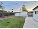 Backyard featuring a well-maintained lawn and versatile storage shed, offering both functionality and outdoor enjoyment at 7943 W Mariposa Dr, Phoenix, AZ 85033