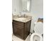 Functional bathroom with granite countertop, dark wood vanity, and a modern toilet at 7943 W Mariposa Dr, Phoenix, AZ 85033