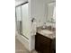 Clean bathroom with a sliding glass shower door, granite countertop and dark wood vanity at 7943 W Mariposa Dr, Phoenix, AZ 85033