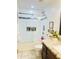Modern bathroom with a glass-enclosed shower, granite countertops and neutral ceramic tile at 7943 W Mariposa Dr, Phoenix, AZ 85033