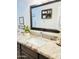 Bright bathroom with granite countertops, white sink, dark vanity and a large mirror at 7943 W Mariposa Dr, Phoenix, AZ 85033