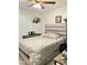 Comfortable bedroom featuring a padded headboard, modern ceiling fan, and neutral tones at 7943 W Mariposa Dr, Phoenix, AZ 85033