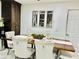 Elegant dining room with decorative mirrors, a wooden table set for a meal, and modern lighting at 7943 W Mariposa Dr, Phoenix, AZ 85033