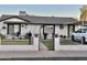 Charming single-story home with a well-manicured front yard, decorative accents, and covered parking in a residential neighborhood at 7943 W Mariposa Dr, Phoenix, AZ 85033