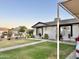 Attractive single-story home boasts a lush lawn, garden, decorative planters, and a covered carport for convenient parking at 7943 W Mariposa Dr, Phoenix, AZ 85033