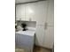 This laundry room features plenty of cabinet storage and additional freezer at 7943 W Mariposa Dr, Phoenix, AZ 85033