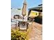 Relaxing patio area featuring an outdoor table, umbrella, and fireplace in a landscaped setting at 7943 W Mariposa Dr, Phoenix, AZ 85033
