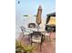 Outdoor patio with an umbrella-covered table set and a charming outdoor fireplace at 7943 W Mariposa Dr, Phoenix, AZ 85033