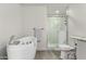 Bathroom featuring a soaking tub, walk-in shower with marble-style tiling, and modern wood-look flooring at 819 N Robson --, Mesa, AZ 85201