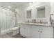 Nicely updated bathroom featuring a shower and double-sink vanity with granite countertops and wooden-style flooring at 819 N Robson --, Mesa, AZ 85201