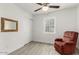 Bedroom features a ceiling fan, closet, wood-look flooring, and a comfortable red armchair at 819 N Robson --, Mesa, AZ 85201