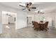 Open dining room with gray wood-look tile, ceiling fan, and bright white walls at 819 N Robson --, Mesa, AZ 85201