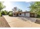 This home features a spacious driveway, shade trees, and a low-maintenance desert landscape at 819 N Robson --, Mesa, AZ 85201