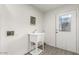 Bright laundry room with a utility sink and backyard access through a glass-paneled door at 819 N Robson --, Mesa, AZ 85201