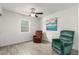 Living room with wood-look floors, a ceiling fan, a large window, and comfortable seating at 819 N Robson --, Mesa, AZ 85201
