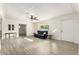 Bright living room with wood-look flooring, a ceiling fan, and abundant natural light at 819 N Robson --, Mesa, AZ 85201