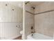 Bathroom featuring tan wall and floor tiles, a bathtub, and decorative fixtures at 8306 E Via De Dorado --, Scottsdale, AZ 85258