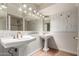 A spacious bathroom showcasing double sinks, a large mirror, decorative lighting and wainscotting at 8306 E Via De Dorado --, Scottsdale, AZ 85258