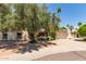 Charming single-story home featuring a well-manicured front yard, mature trees, and an attached two-car garage at 8306 E Via De Dorado --, Scottsdale, AZ 85258