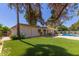 Expansive backyard featuring a covered patio, lush green lawn, and a private swimming pool, ideal for outdoor living at 8306 E Via De Dorado --, Scottsdale, AZ 85258