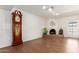 Living room showcasing a charming fireplace, wood floors, and a classic grandfather clock at 8306 E Via De Dorado --, Scottsdale, AZ 85258