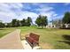 Inviting park bench next to a curved sidewalk and overlooking a grassy field with lush trees and blue skies at 8306 E Via De Dorado --, Scottsdale, AZ 85258
