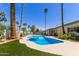 Inviting backyard pool surrounded by lush landscaping and tall palm trees, perfect for relaxation and entertaining at 8306 E Via De Dorado --, Scottsdale, AZ 85258