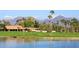 Scenic water view of home overlooking a golf course, framed by palm trees and mountains, perfect for luxury living at 8306 E Via De Dorado --, Scottsdale, AZ 85258