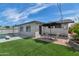 Charming backyard with artificial grass, a patio, and views of the inviting pool area at 8316 E Glenrosa Ave, Scottsdale, AZ 85251