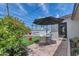 Backyard features a cozy patio, artificial grass, beautiful hibiscus, and views of the sparkling pool at 8316 E Glenrosa Ave, Scottsdale, AZ 85251