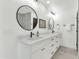 Well-lit bathroom featuring dual sinks, round mirrors and modern lighting at 8316 E Glenrosa Ave, Scottsdale, AZ 85251