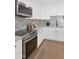 Gourmet kitchen with stainless appliances, white cabinets, and wood floors at 8316 E Glenrosa Ave, Scottsdale, AZ 85251
