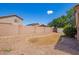 Enclosed backyard with gravel landscaping, low-maintenance lawn, block fence, and a storage shed at 8648 W Fargo Dr, Peoria, AZ 85382
