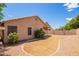 Gravel backyard with partial grass, covered patio, and house exterior at 8648 W Fargo Dr, Peoria, AZ 85382