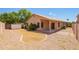Backyard features gravel, partial grass area, covered patio, and privacy fence at 8648 W Fargo Dr, Peoria, AZ 85382