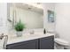 Bathroom with a gray vanity, undermount sink, artwork and framed mirror at 8648 W Fargo Dr, Peoria, AZ 85382