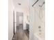 Bathroom with tub and shower, gray vanity, and wood-look floors at 8648 W Fargo Dr, Peoria, AZ 85382