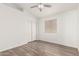 Bedroom with wood-look floors, double closet, and window with blinds at 8648 W Fargo Dr, Peoria, AZ 85382