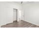 Bedroom with wood-look floors, closet with double doors, and neutral paint at 8648 W Fargo Dr, Peoria, AZ 85382