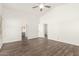 Neutral bedroom with wood-look floors, ceiling fan, and doorways to other rooms at 8648 W Fargo Dr, Peoria, AZ 85382