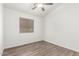 Bedroom with wood-look floors, window with blinds, and white walls at 8648 W Fargo Dr, Peoria, AZ 85382