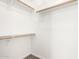 Walk-in closet with white walls and wood closet rods at 8648 W Fargo Dr, Peoria, AZ 85382