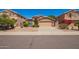 Charming single-story home with a well-maintained front yard and two-car garage at 8648 W Fargo Dr, Peoria, AZ 85382