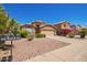 Inviting home exterior featuring desert landscaping and a well-kept facade with a two-car garage at 8648 W Fargo Dr, Peoria, AZ 85382