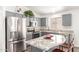 Modern kitchen with stainless steel appliances, granite countertops, and stylish gray cabinetry at 8648 W Fargo Dr, Peoria, AZ 85382
