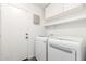 Laundry room with cabinets, shelving, and washer and dryer at 8648 W Fargo Dr, Peoria, AZ 85382