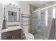 Updated bathroom with glass-enclosed shower and modern vanity at 905 E Bluefield Ave, Phoenix, AZ 85022