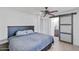 Comfortable main bedroom with ceiling fan and barn door to ensuite bathroom at 905 E Bluefield Ave, Phoenix, AZ 85022